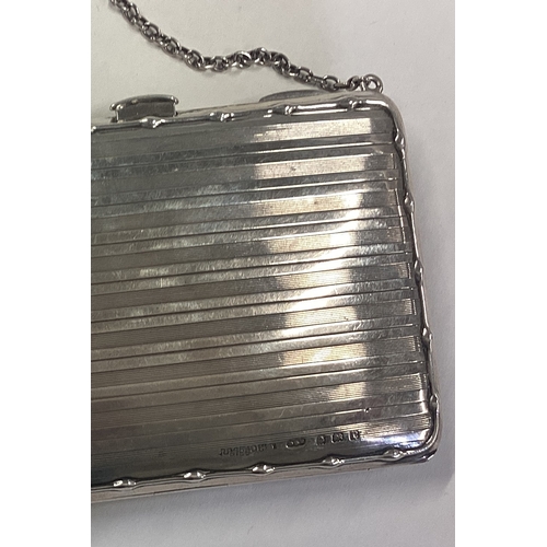 314 - An engine turned silver card case with suspended chain. Birmingham 1912. Approx. 132 grams. Est. £80... 