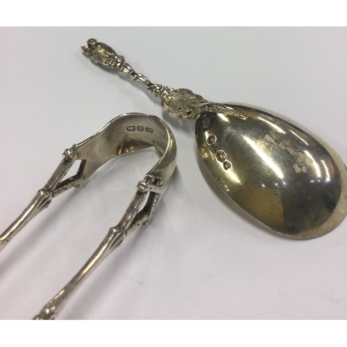 324 - A pair of Naturalistic silver tongs together with a matching Apostle top spoon. Sheffield 1910. Appr... 