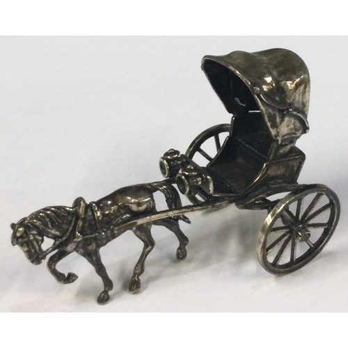 336 - A novelty silver toy horse drawn carriage. Approx. 37 grams. Est. £30 - £40.