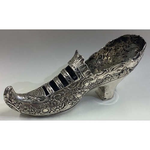 389 - A large German silver model of a shoe with embossed decoration. Marked to base. Approx. 100 grams. E... 