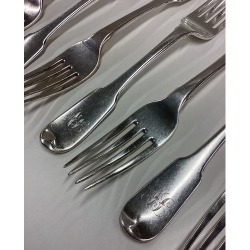 402 - A matched set of nine heavy silver fiddle pattern table forks. London. By WE. Approx. 630 grams. Est... 