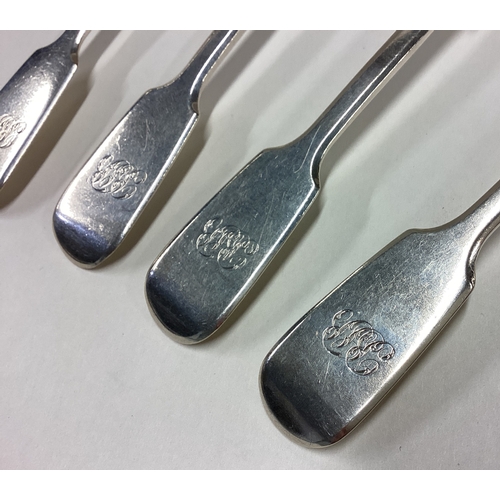 469 - A heavy set of four silver fiddle pattern dessert spoons. London. By RW. Approx. 200 grams. Est. £60... 