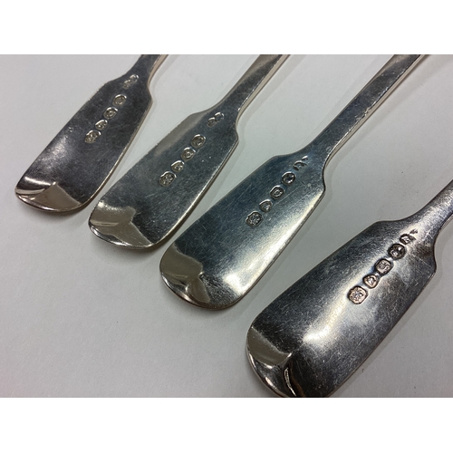 469 - A heavy set of four silver fiddle pattern dessert spoons. London. By RW. Approx. 200 grams. Est. £60... 