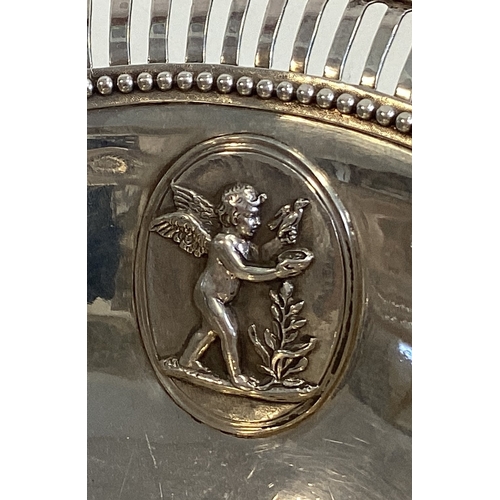 515 - A fine 18th Century George III silver basket with applied panels and cherub decoration. London 1778.... 