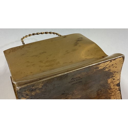 516 - CARTIER: A silver gilt model of a shopping bag. Marked Sterling. Approx. 84 grams. Est. £200 - £300.