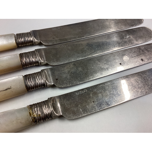 521 - WANG HING: A set of four Chinese export silver and MOP knives. Approx. 237 grams. Est. £120 - £150.