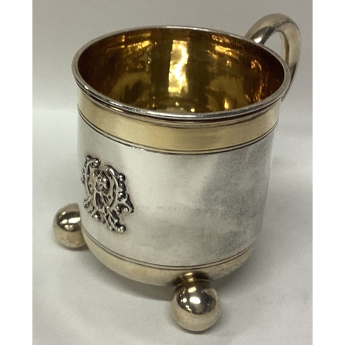 562 - A fine quality Victorian silver and parcel-gilt christening cup on ball feet. London. By George Fox.... 