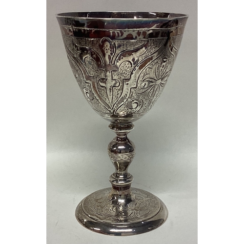 566 - A chased silver goblet decorated with flowers and leaves in the Charles I style. London. by RC. Appr... 