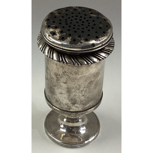 573 - An Indian silver pepper on feet. Circa 1830. Approx. 106 grams. Est. £80 - £120.