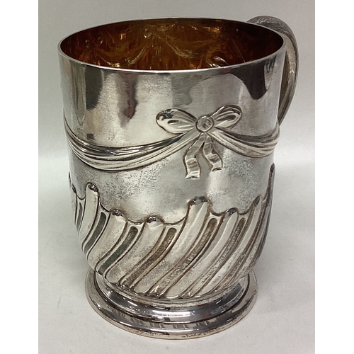 591 - A good quality Victorian silver christening mug with swag decoration to gilt interior. London. By WB... 