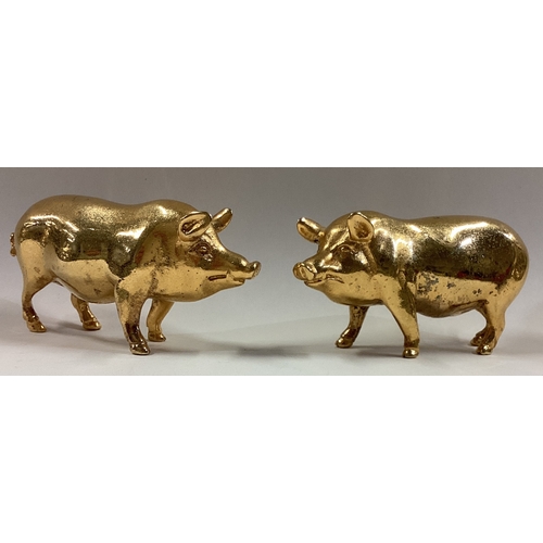 595 - A pair of silver gilt figures of pigs bearing import marks. Birmingham. Approx. 550 grams. Est. £600... 