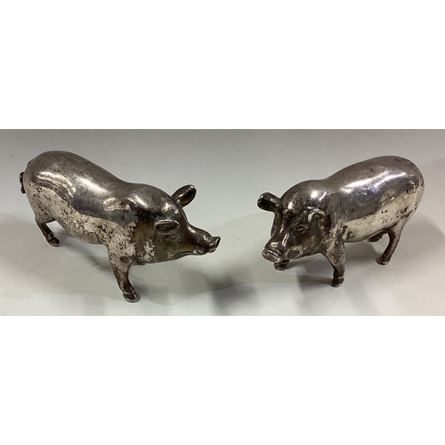 596 - A pair of silver figures of pigs bearing import marks. Birmingham. Approx. 544 grams. Est. £600 - £8... 