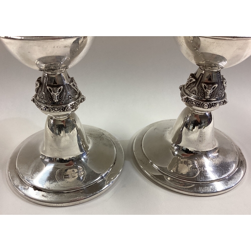 603 - OF HUNTING INTEREST: A pair of silver candlesticks embossed with foxes. Birmingham 1965. By DL. Appr... 