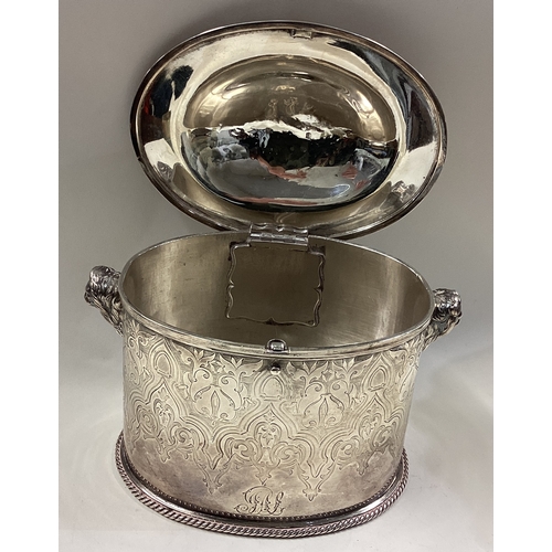 626 - GLASGOW: A Scottish Victorian silver hinged tea caddy chased with lions to handles. 1859. By Joseph ... 