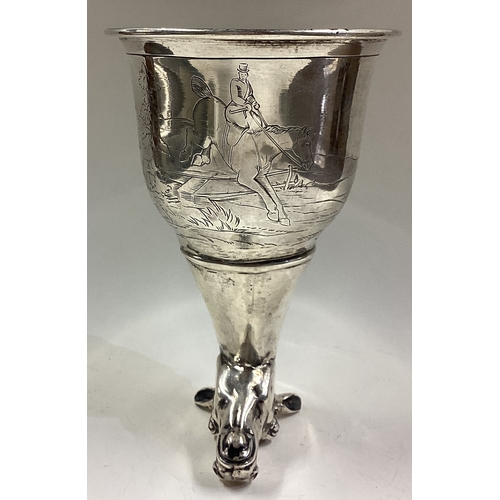 668 - CHESTER: OF HUNTING INTEREST: A silver horse head stirrup cup engraved with horse riding and dog hun... 