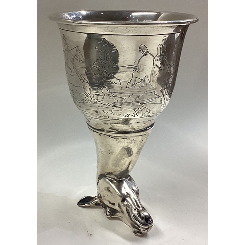 668 - CHESTER: OF HUNTING INTEREST: A silver horse head stirrup cup engraved with horse riding and dog hun... 