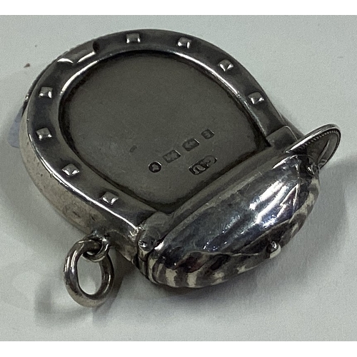 713 - An unusual silver vesta case in the form of a jockey's cap with horseshoe border. Birmingham 1880. B... 