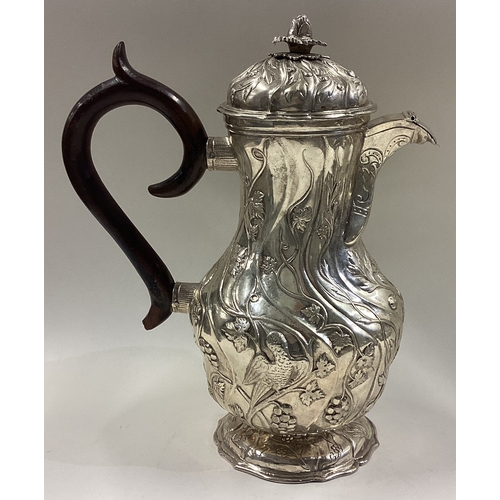 73 - A Continental silver coffee pot with embossed decoration. Approx. 344 grams. Est. £80 - £120.