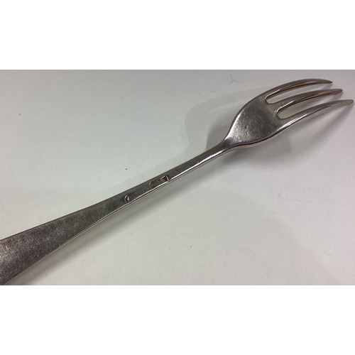 743 - An 18th Century three-pronged silver fork. Approx. 34 grams. Est. £50 - £80.