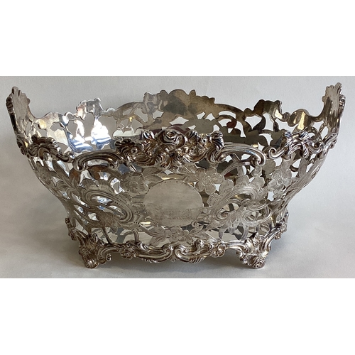 749 - An attractive pierced silver basket decorated with flowers and leaves. London. By CSH. Approx. 446 g... 