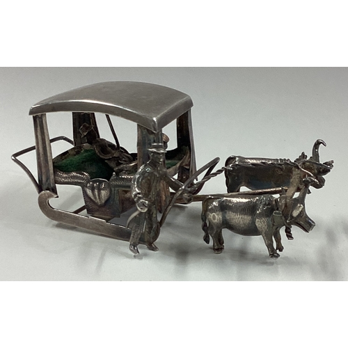 75 - A silver toy ox drawn carriage. Approx. 62 grams. Est. £60 - £80.