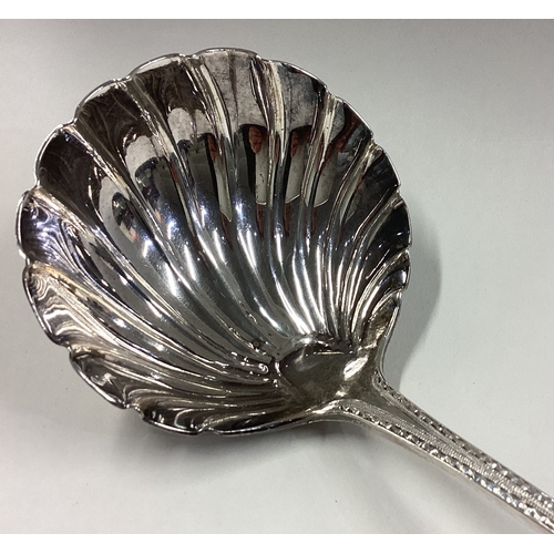 761 - A good bright-cut silver soup ladle with fluted bowl to crested terminal in the Georgian style. Shef... 