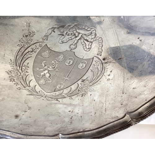 780 - A large Georgian silver circular salver attractively decorated with impressive crest to beaded rim o... 