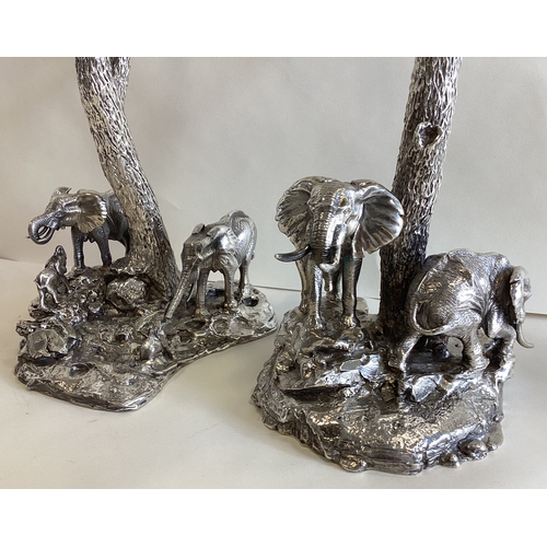 795 - PATRICK MAVROS: A fine and heavy pair of Naturalistic cast silver candlesticks depicting elephants a... 