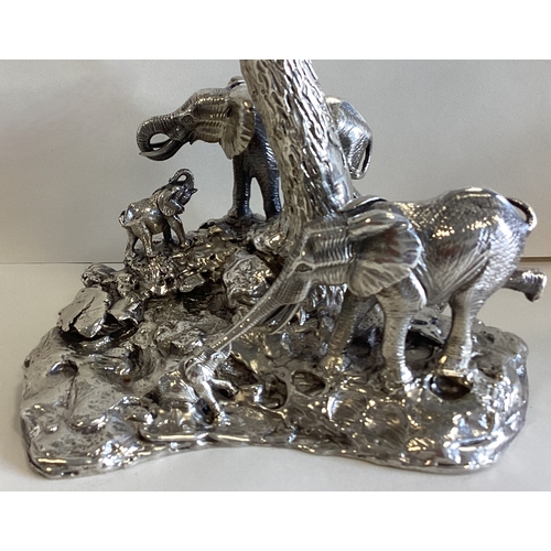 795 - PATRICK MAVROS: A fine and heavy pair of Naturalistic cast silver candlesticks depicting elephants a... 