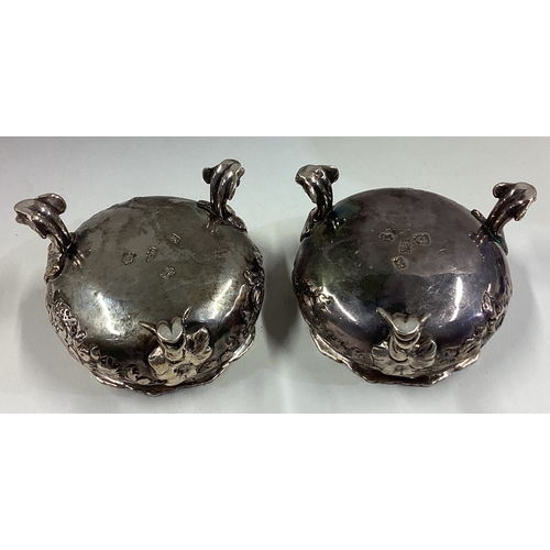 81 - A pair of 18th Century silver salt cellars with chased decoration. London 1752. By Fuller White. App... 