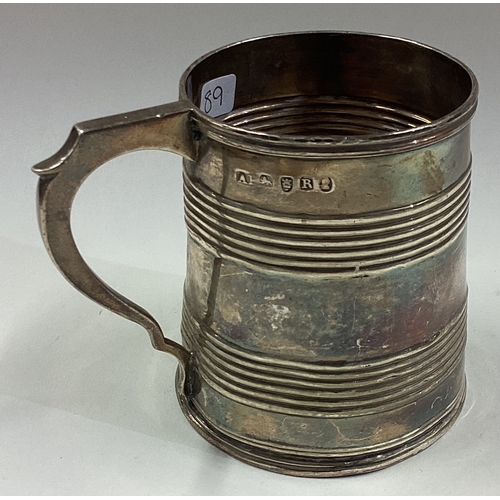 89 - A Georgian silver mug with reeded decoration. London 1812. By AP. Approx. 85 grams. Est. £100 - £150... 