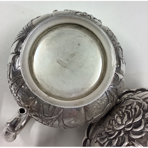 474 - A Chinese export silver sugar and cream set embossed with flowers. Character marks to base. By HC. A... 