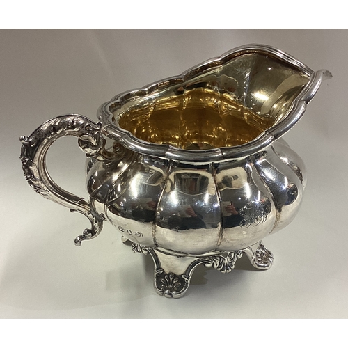 309 - A good quality Georgian silver fluted cream jug. Sheffield. By HE. Approx. 268 grams. Est. £100 - £1... 