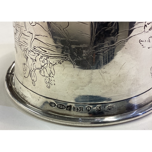 668 - CHESTER: OF HUNTING INTEREST: A silver horse head stirrup cup engraved with horse riding and dog hun... 