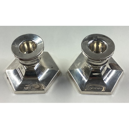 125 - A pair of octagonal silver candlesticks. Birmingham 1964. By T&S. Approx. 359 grams. Est. £80 - £120... 