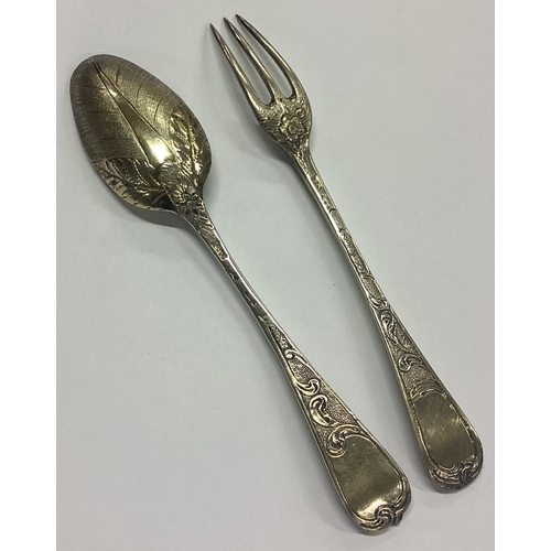 141 - A good quality two-piece silver gilt christening set with floral decoration. London. Approx. 66 gram... 