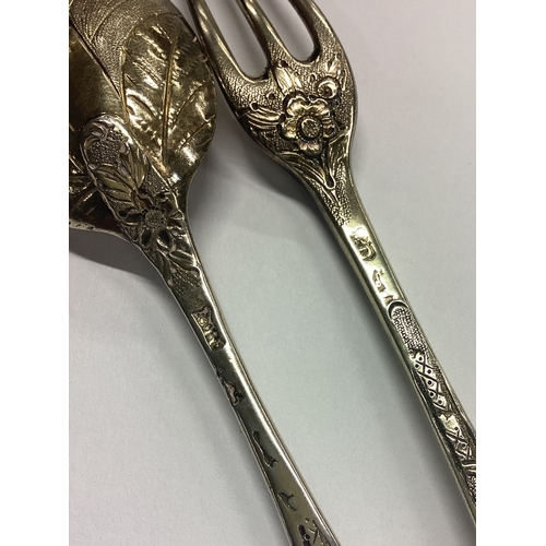 141 - A good quality two-piece silver gilt christening set with floral decoration. London. Approx. 66 gram... 