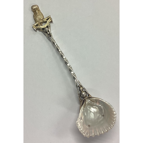 142 - A good quality silver parcel-gilt preserve spoon with shell bowl cast with bird to terminal. Birming... 