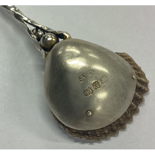 142 - A good quality silver parcel-gilt preserve spoon with shell bowl cast with bird to terminal. Birming... 