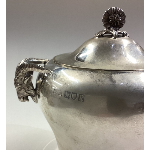 149 - An unusual silver tea caddy cast with figural ram head handles. Fully marked to cover and body. Lond... 