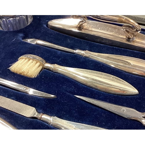 16 - A large cased silver manicure set. Birmingham 1922. Est. £100 - £150.