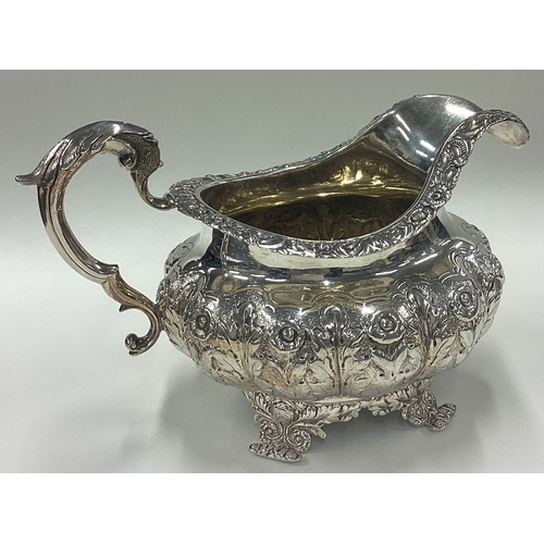 183 - A good Georgian silver cream jug with floral decoration. London. By DC. Approx. 281 grams. Est. £80 ... 