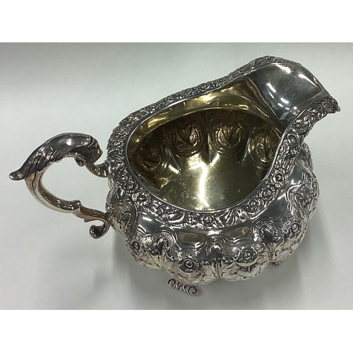 183 - A good Georgian silver cream jug with floral decoration. London. By DC. Approx. 281 grams. Est. £80 ... 