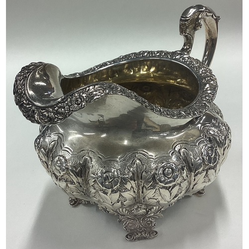 183 - A good Georgian silver cream jug with floral decoration. London. By DC. Approx. 281 grams. Est. £80 ... 