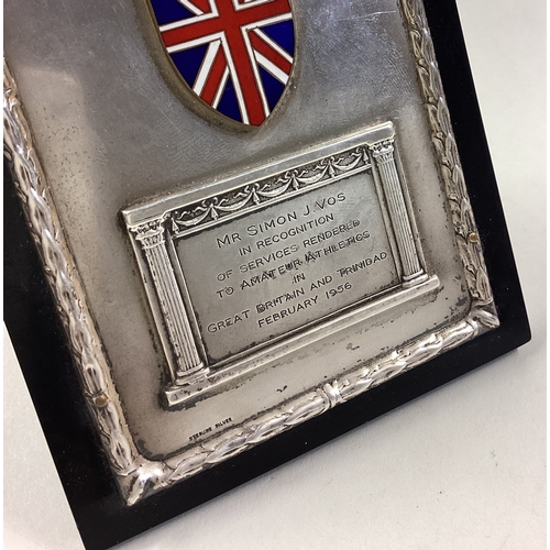 214 - A silver and enamelled presentation frame. Approx. 189 grams. Est. £50 - £80.