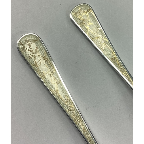 222 - A good pair of tapering silver and enamelled preserve spoons. London. By JS. Approx. 67 grams. Est. ... 