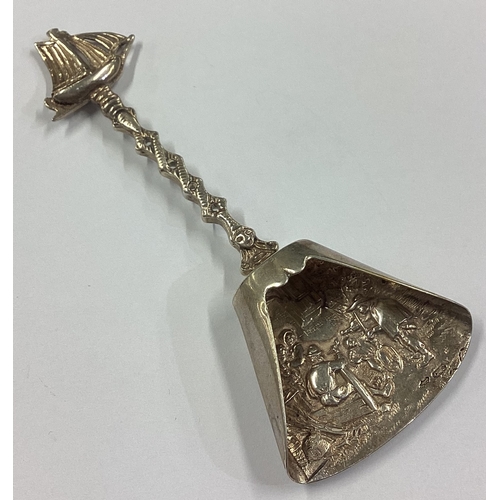 229 - A Dutch silver caddy spoon with embossed decoration and ship terminal. Approx.19 grams. Est. £30 - £... 