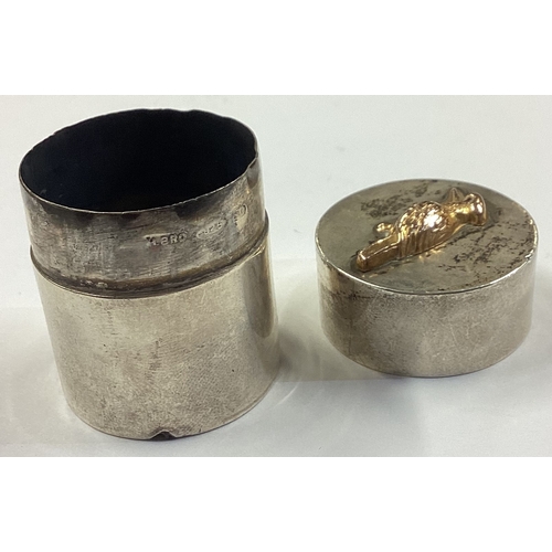 241 - An Australian silver and gold pill box chased with bird decoration. Approx. 24 grams. Est. £100 - £1... 