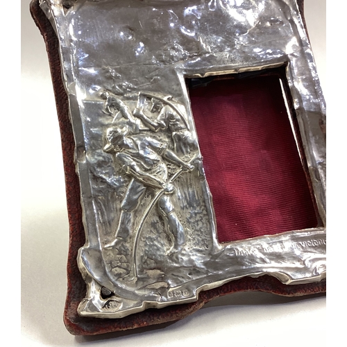 246 - A chased silver frame depicting farmers. Birmingham 1906. Est. £30 - £40.