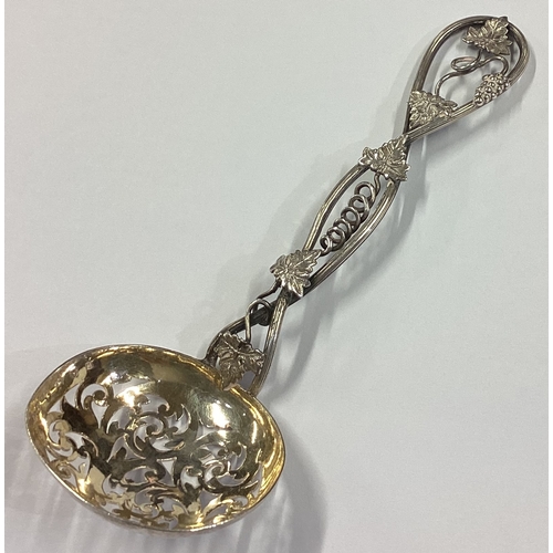 265 - A Victorian silver sifter spoon with grape and vine decoration. Birmingham 1859. By George Unite. Ap... 